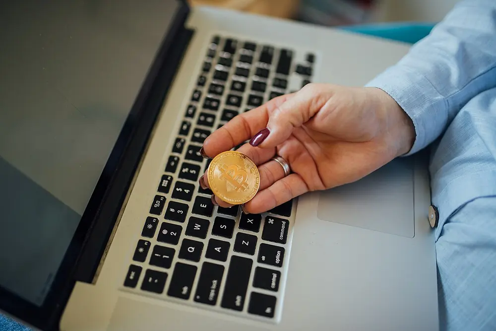 physical bitcoin coin held in a hand