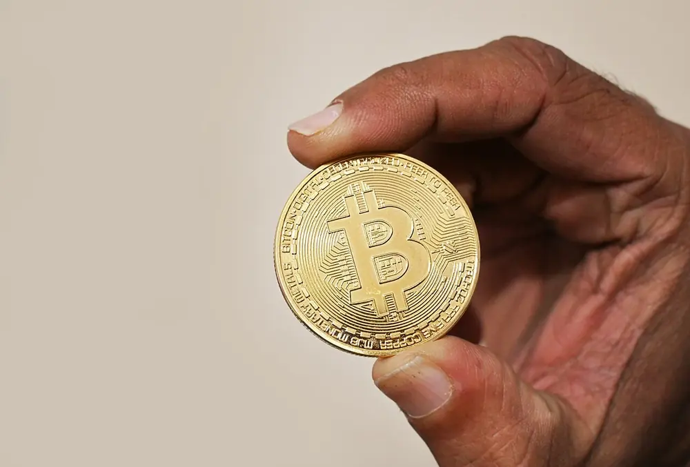 holding a bitcoin coin